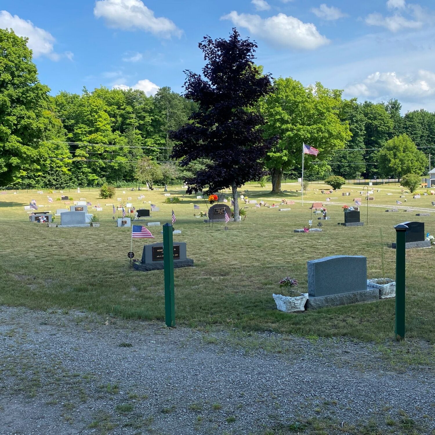 Peaceful cemetery with headstones and American flags