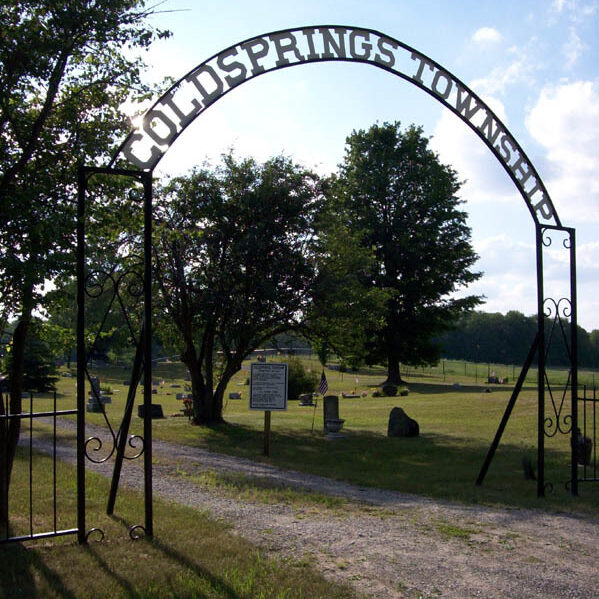 Coldsprings Township cemetery entrance with trees and graves.