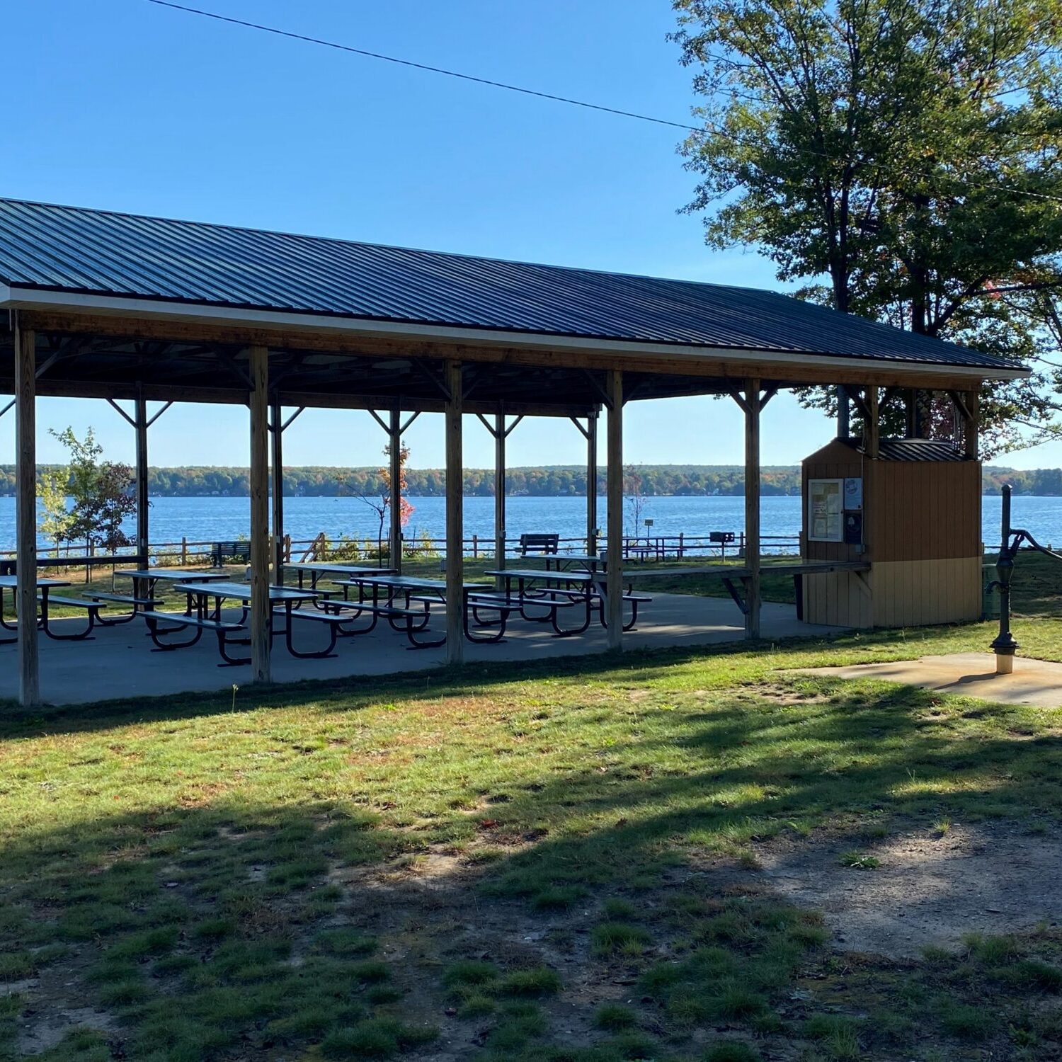 Lakeside picnic pavilion in a sunny park.